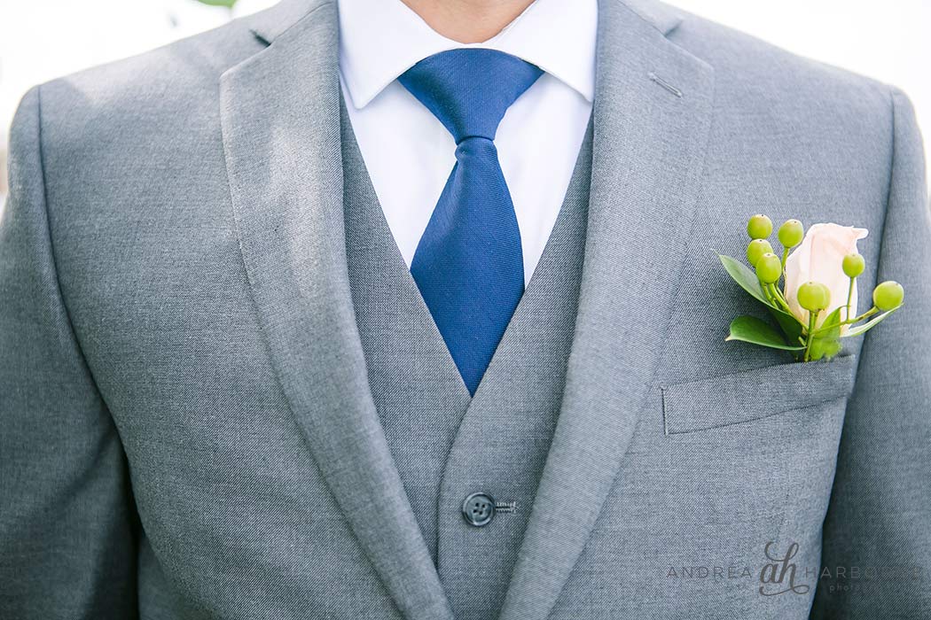 Groomsmen getting ready with yellow rose boutonniere 