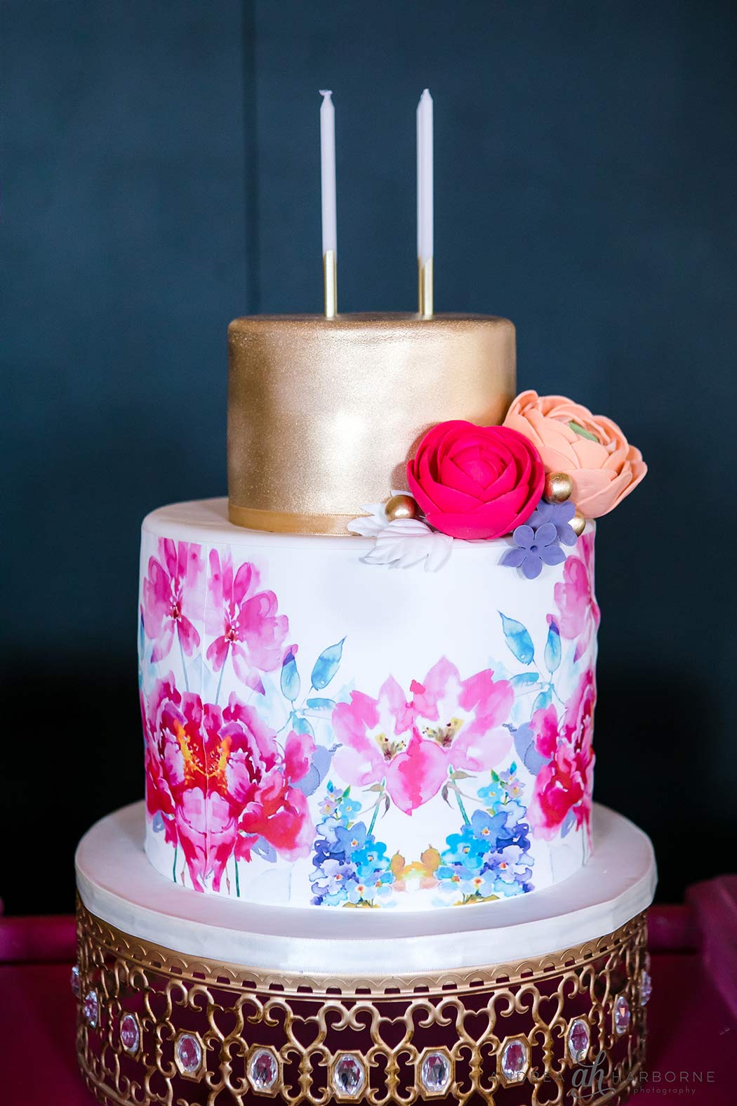 floral birthday cake with gold top tier