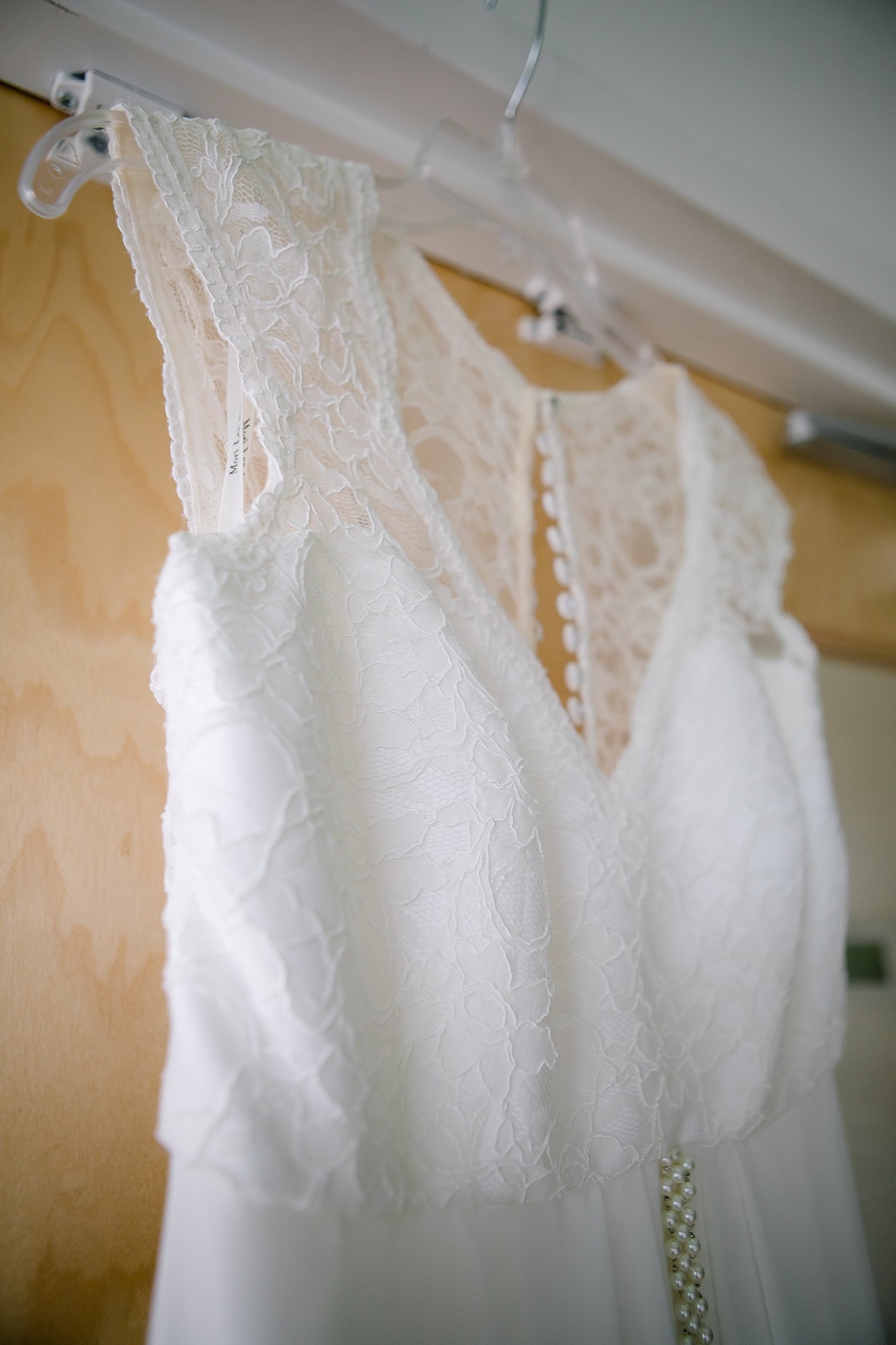 bridal dress hanging in hotel before ceremony