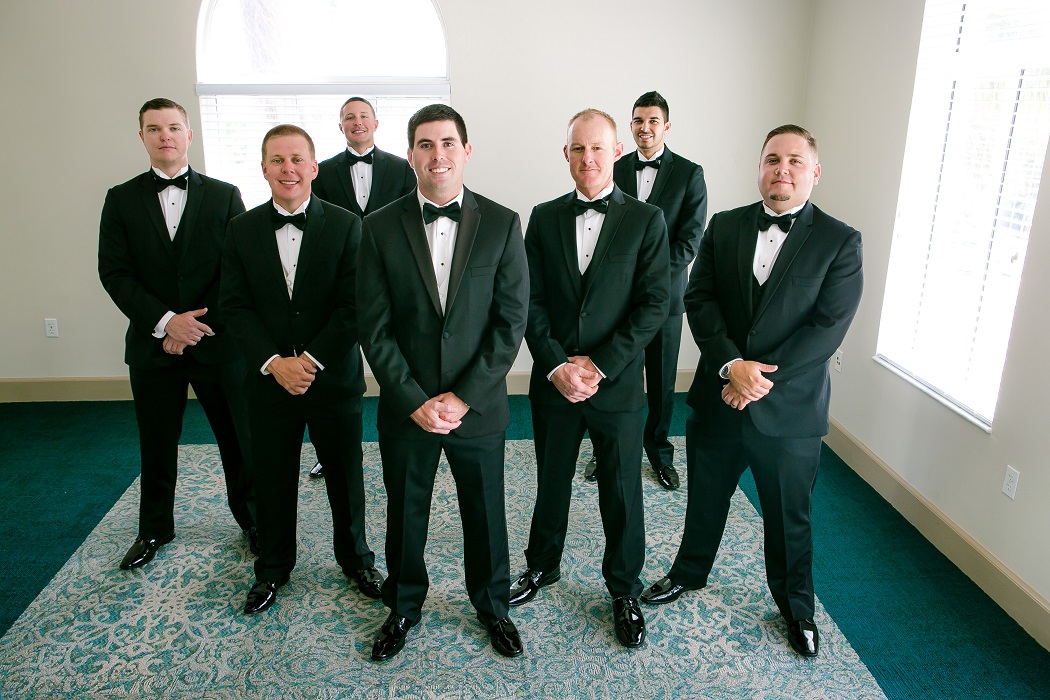 groom poses with his groomsmen