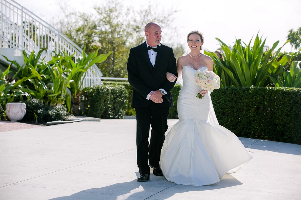 groom walks his daughter down the aisle