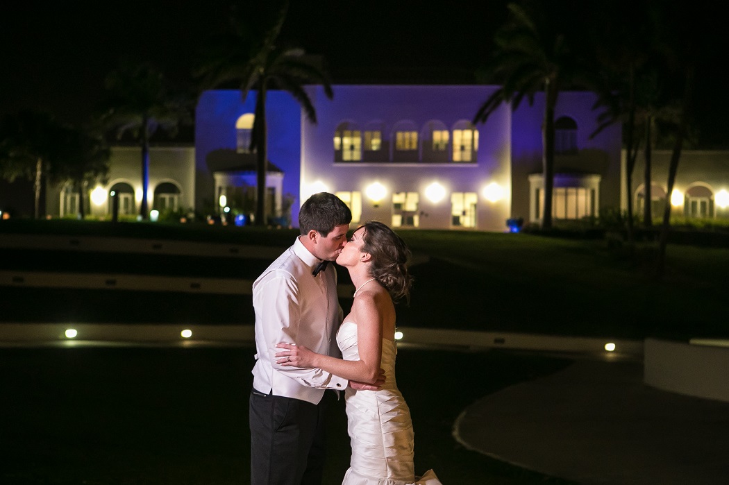 bride and groom kiss outside the mansion at tuckahoe