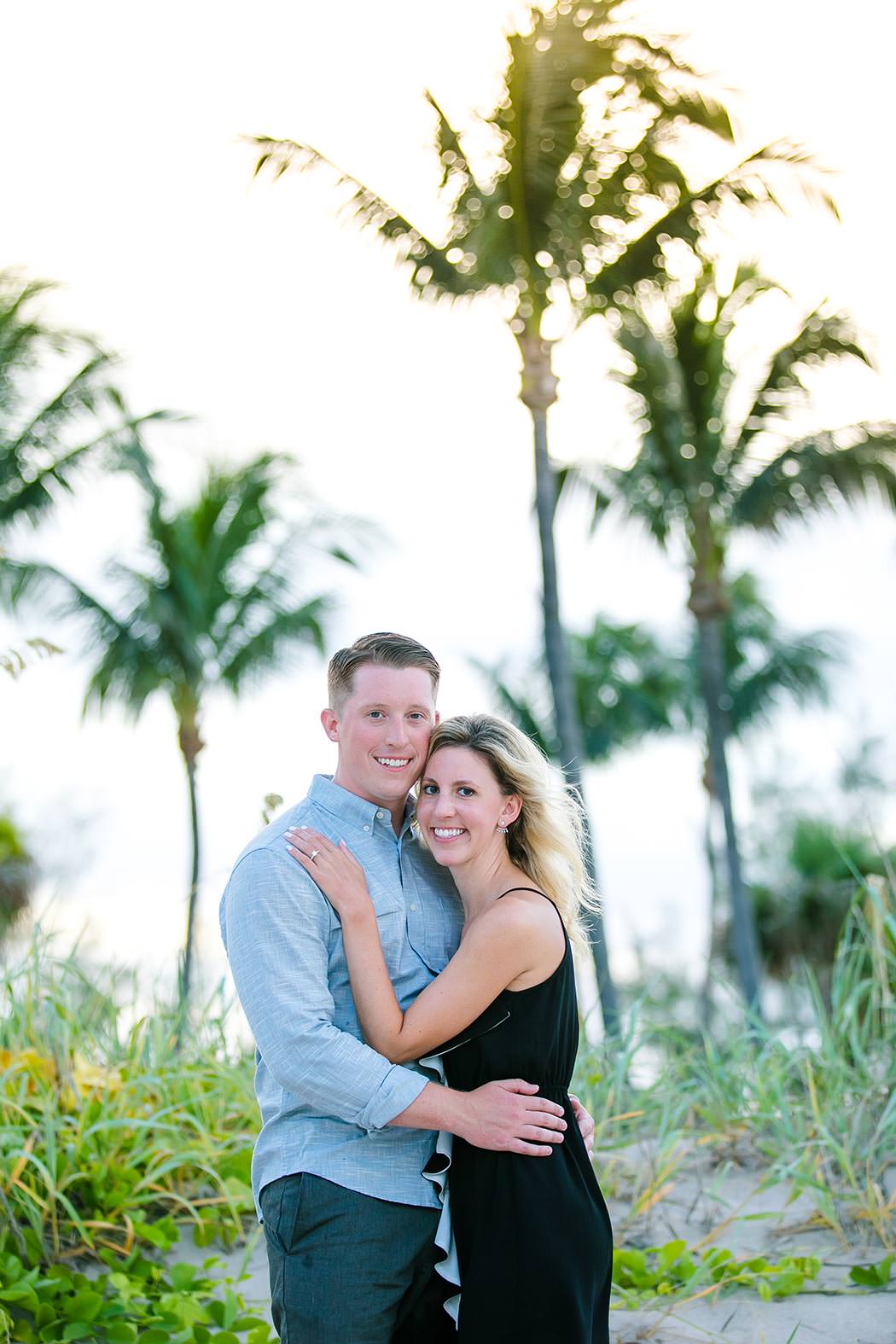 couple pose with engagement ring