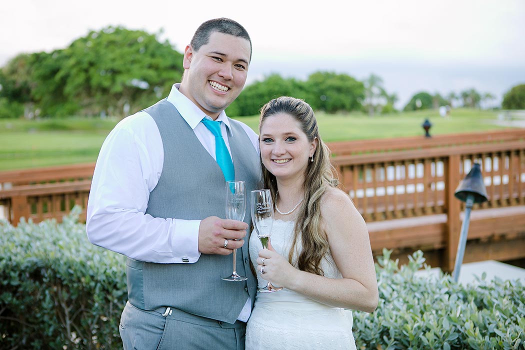 bride and groom celebrate their wedding with signature champagne flutes