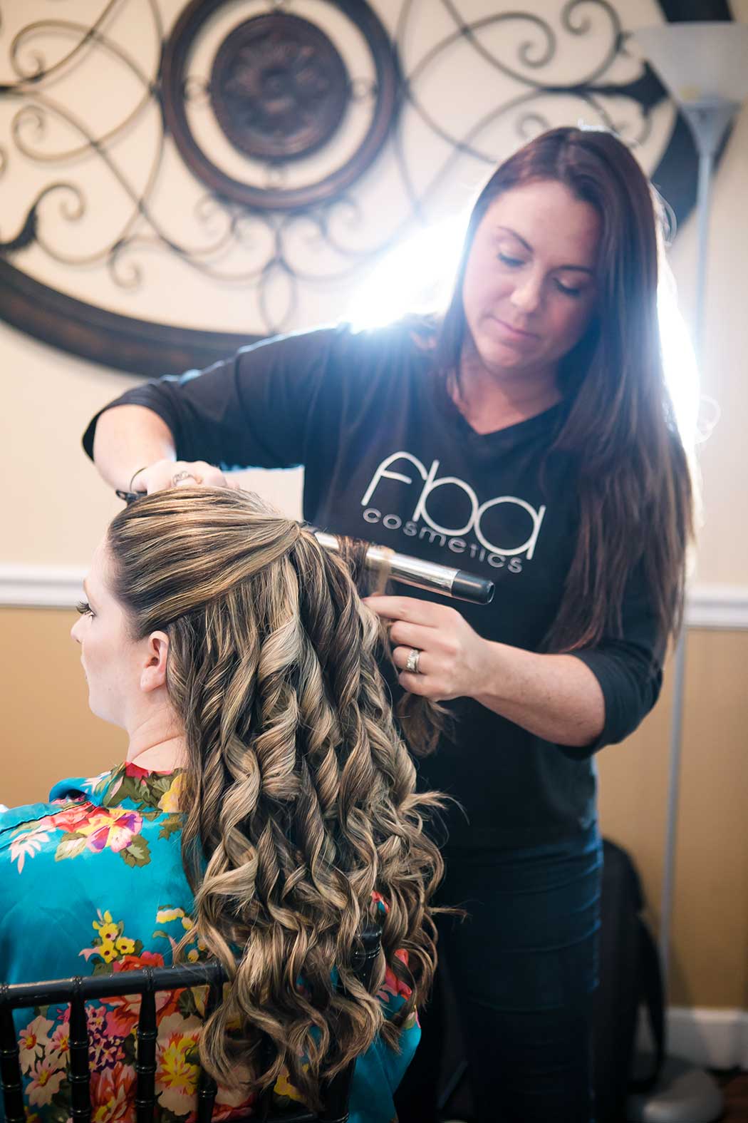 bride gets her hair curled for her galuppi's wedding ceremony in pompano beach