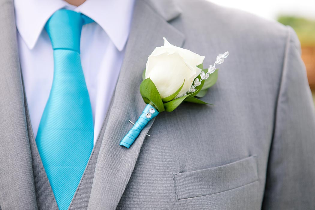 white rose boutonniere with teal ribbon and tie 