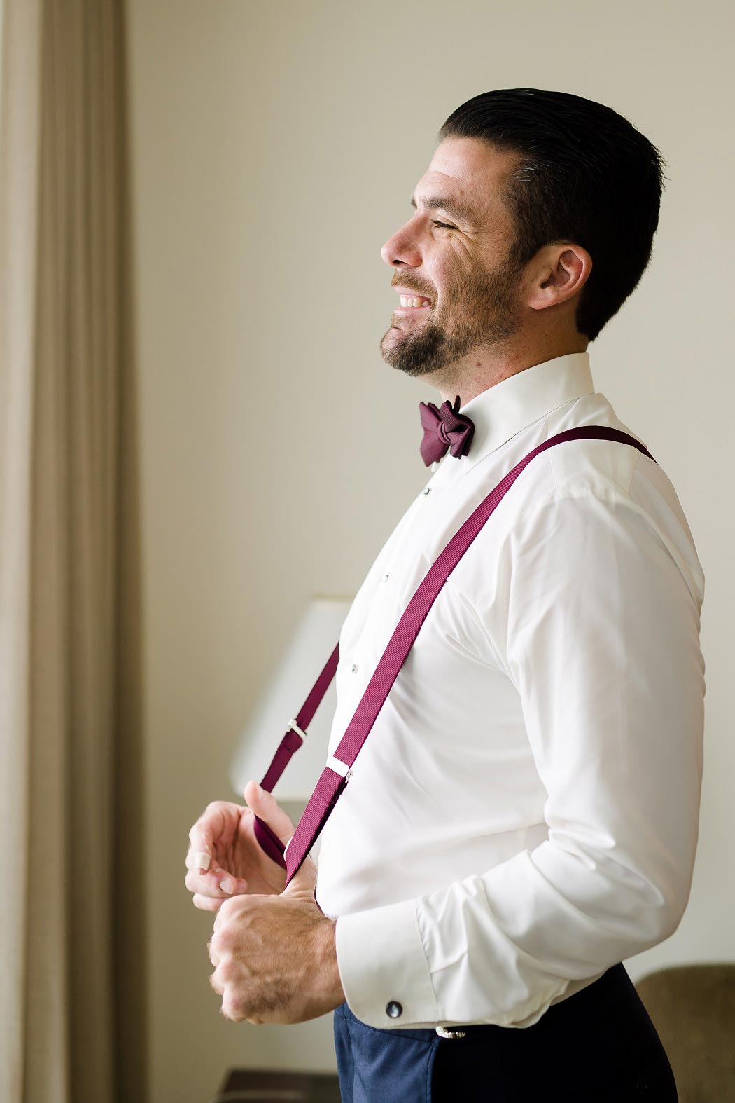 groom getting ready at biltmore hotel miami | red groom suspenders and bow tie | andrea harborne photography