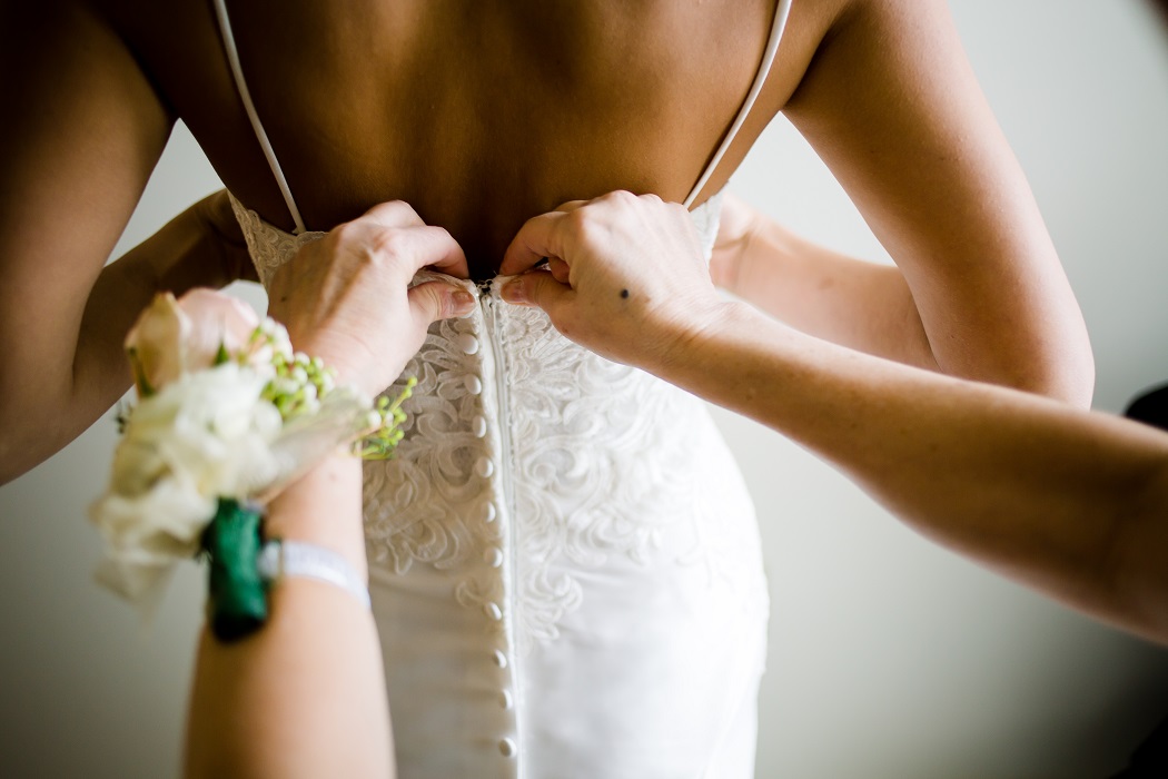 bride photography getting into dress | mother of bride helps bride dress | biltmore hotel miami wedding