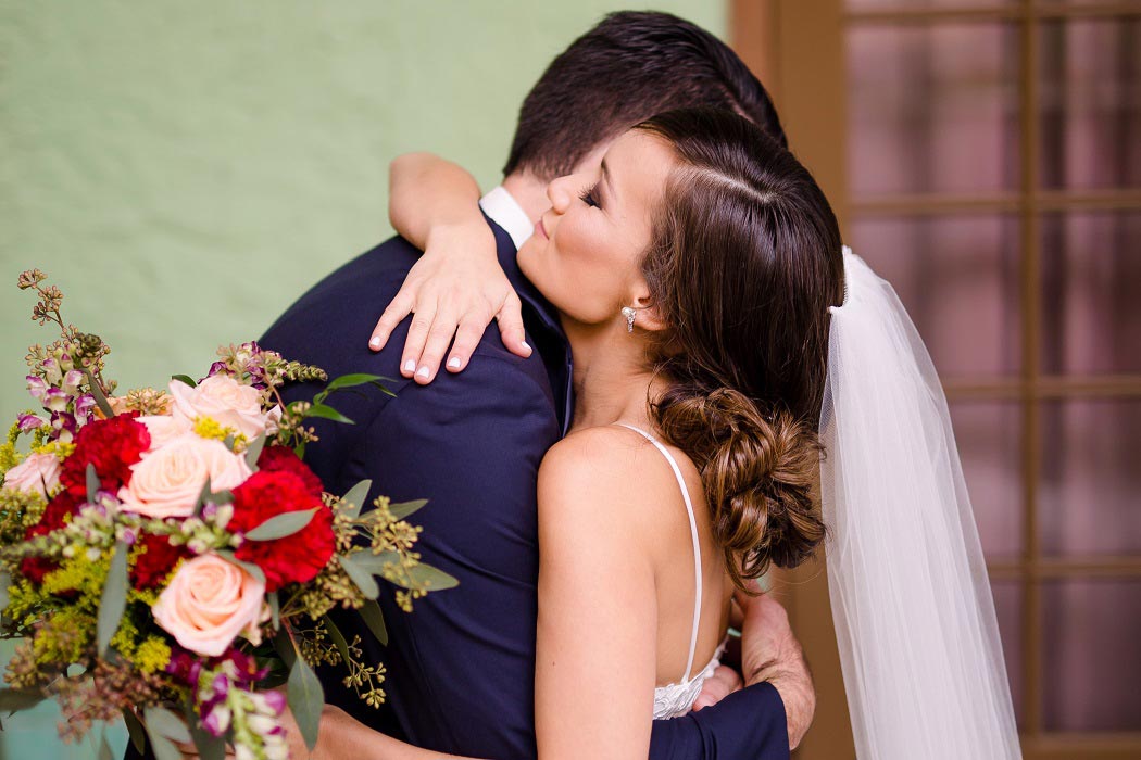 bride hugs groom after first look at biltmore hotel miami | biltmore hotel miami modern wedding 