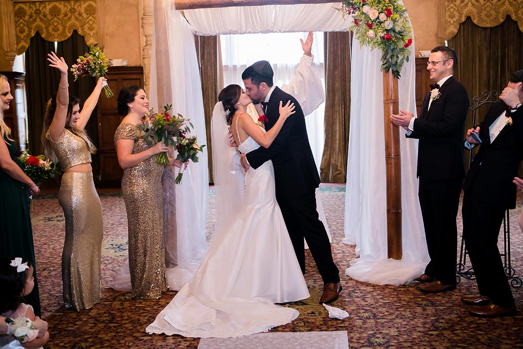 bride and groom kiss during modern wedding ceremony at biltmore hotel miami