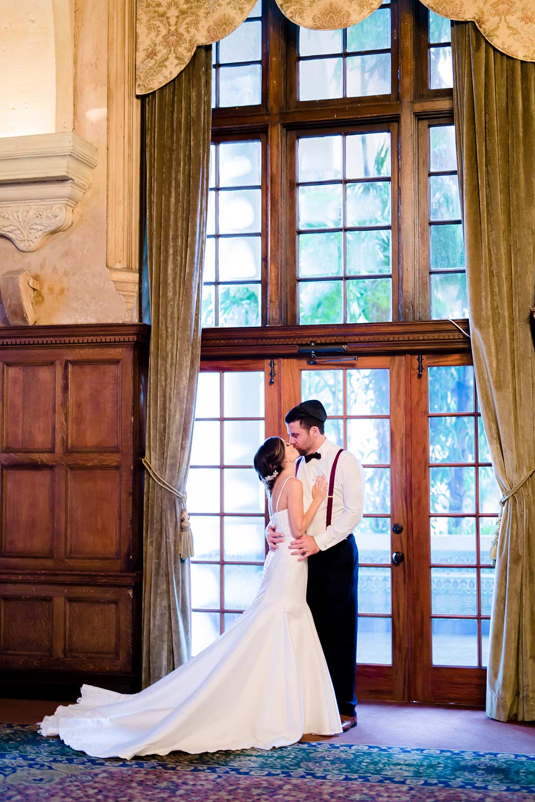 bride and groom kiss in ballroom of biltmore hotel miami | modern wedding ceremony in miami