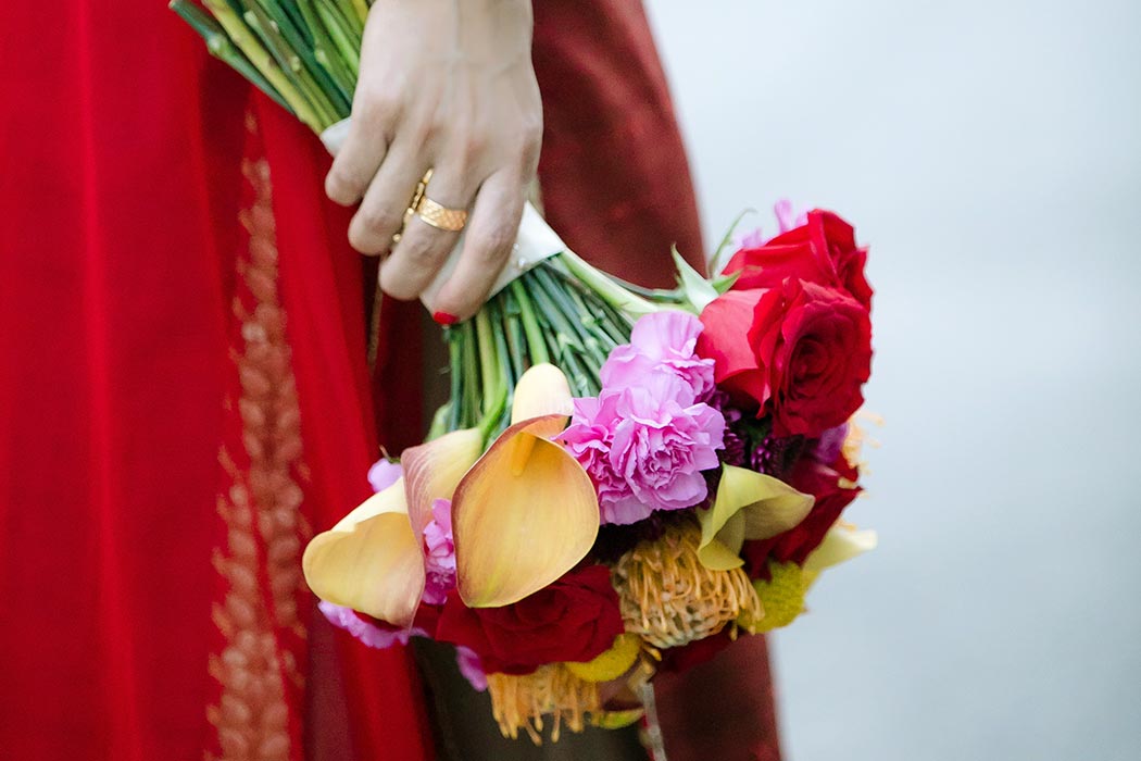 beautiful modern indian wedding bouquet with red, pink and gold flowers | fort lauderdale wedding photographer