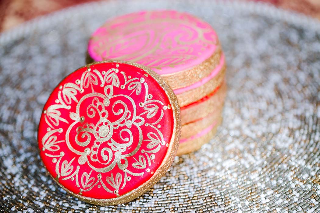 modern indian henna cookies in pink, red and gold