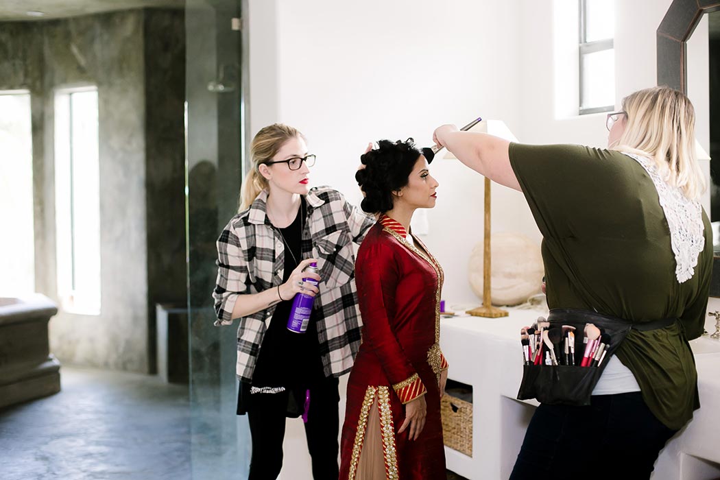 indian wedding bride gets her hair and makeup done