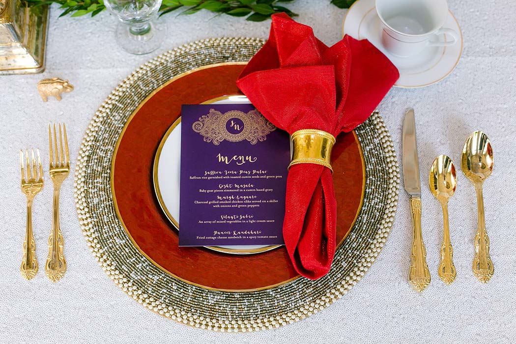 red, gold and white table setting for modern indian wedding