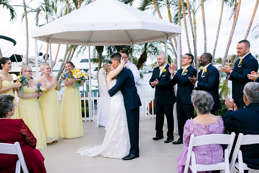 bride and groom kiss after wedding ceremony