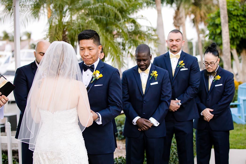 bride and groom say i do during wedding ceremony at lighthouse point yacht club