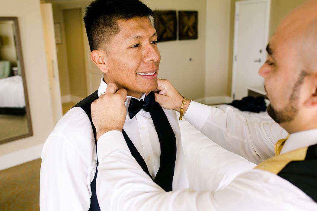 groom getting ready before nautical themed wedding