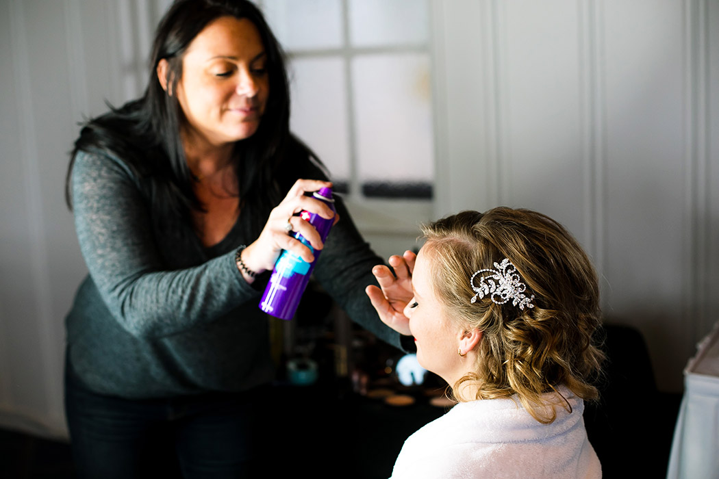 bride getting her hair done before her nautical themed wedding