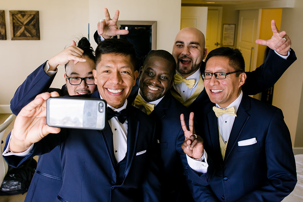 groomsmen pose for selfie before nautical themed wedding