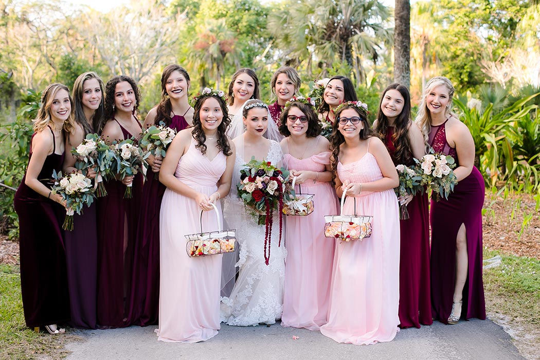 bride and bridesmaids pose at flamingo gardens wedding