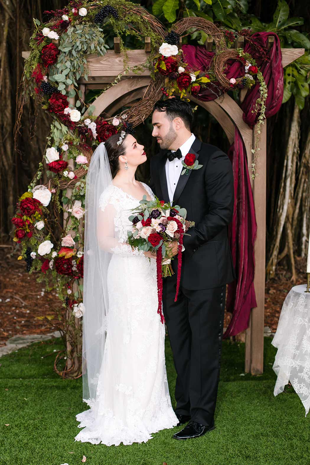 bride and groom pose for bridal portraits at flamingo gardens wedding