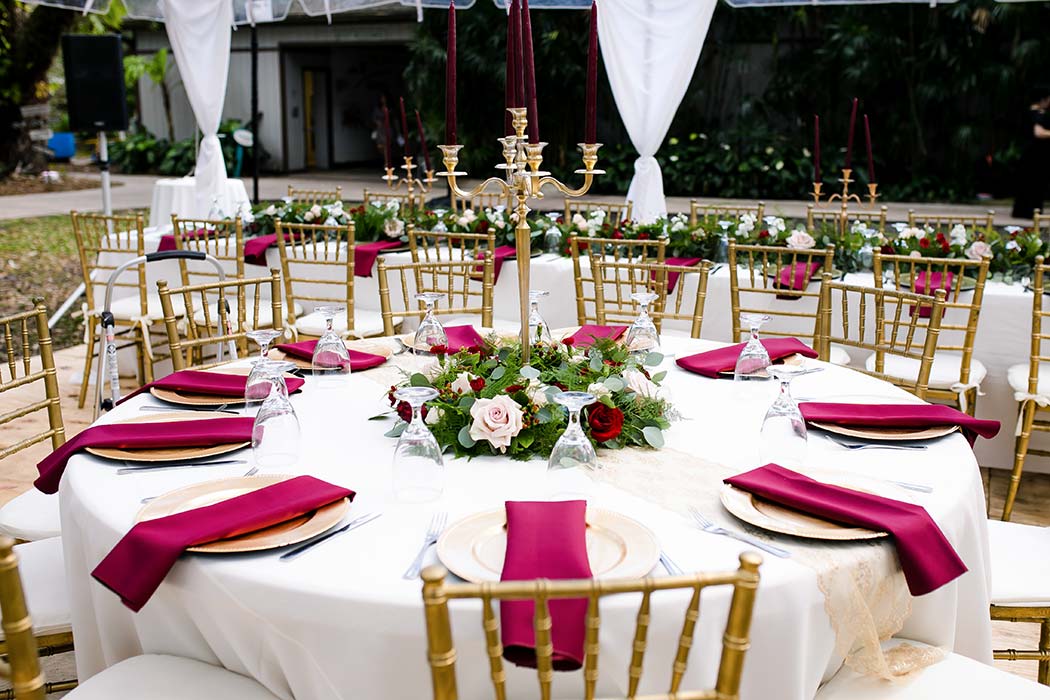 dark red and gold wedding table setting for rustic wedding