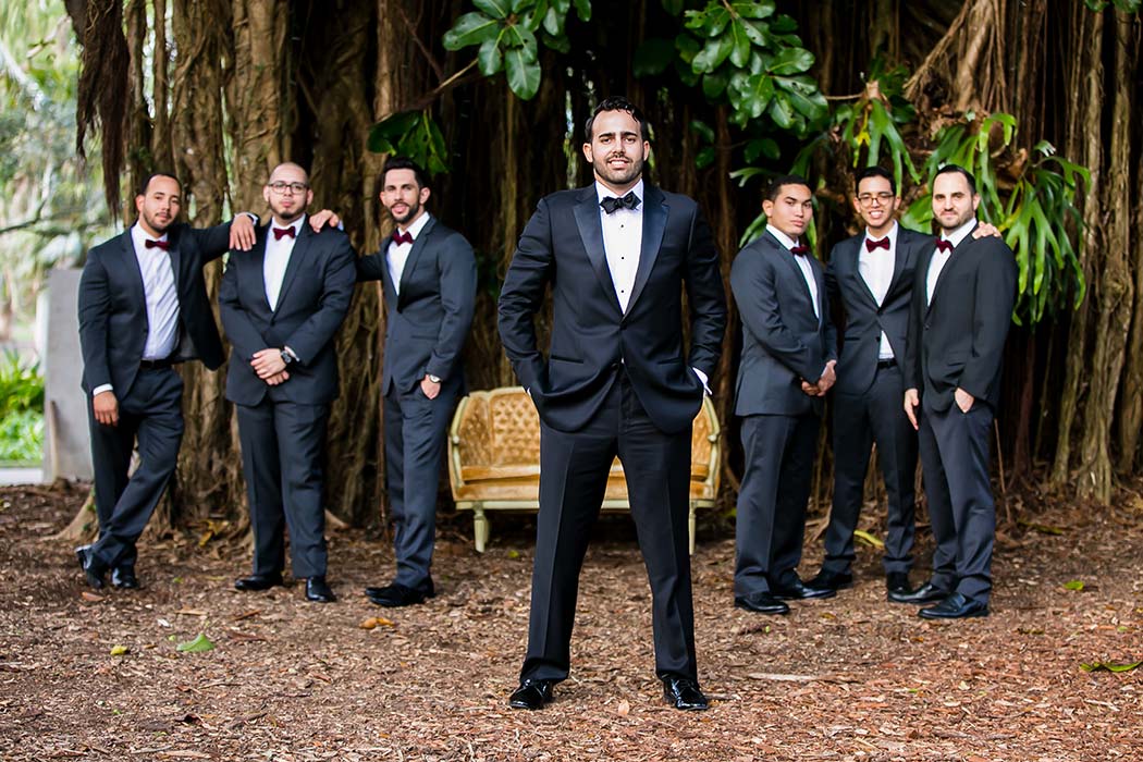 unique posing for groomsmen at rustic wedding