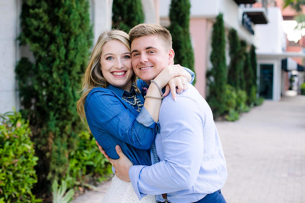 hugging couple on las olas boulevard | engagement photoshoot