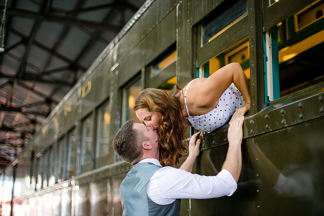 couple kissing on train carriages | vintage inspired engagement session on train | miami railroad museum engagement photoshoot