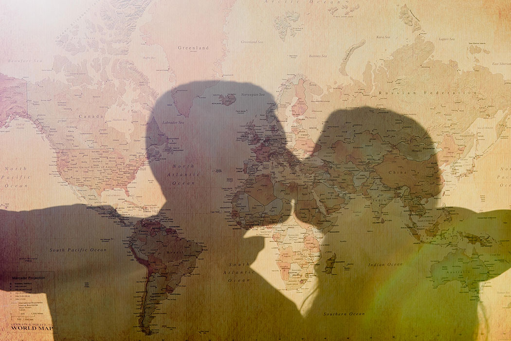 silhouette of couple through a travel map | silhouette of couple for engagement photography | map silhouette of couple