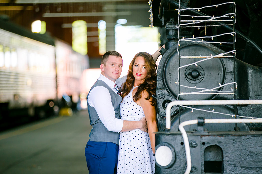 engagement photography session standing next to vintage train | vintage engagement photoshoot | railroad museum miami engagement session