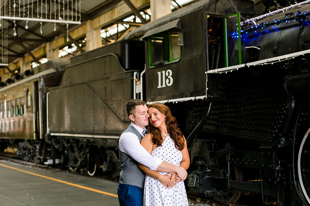 couple hugging in engagement photoshoot | vintage theme engagement | engagement in railway | engagement in railroad museum miami