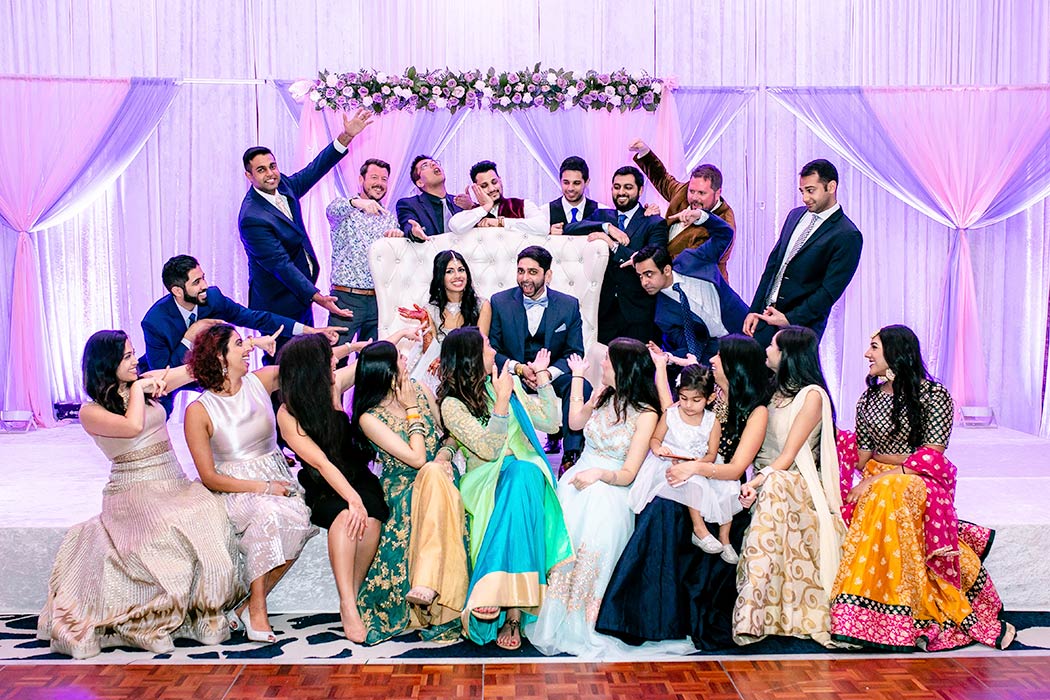 indian family group photograph on stage at wedding