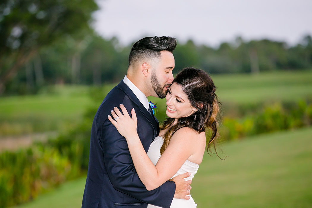 groom kisses bride on cheek | bride and groom on golf course | fort lauderdale wedding photographer