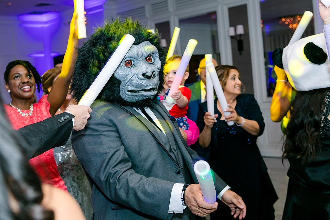 candid wedding reception photograph with gorilla holding lightsticks