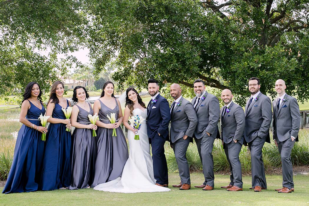 bridal party during modern wedding ceremony at breakers west country club | navy blue and grey bridemaids dresses