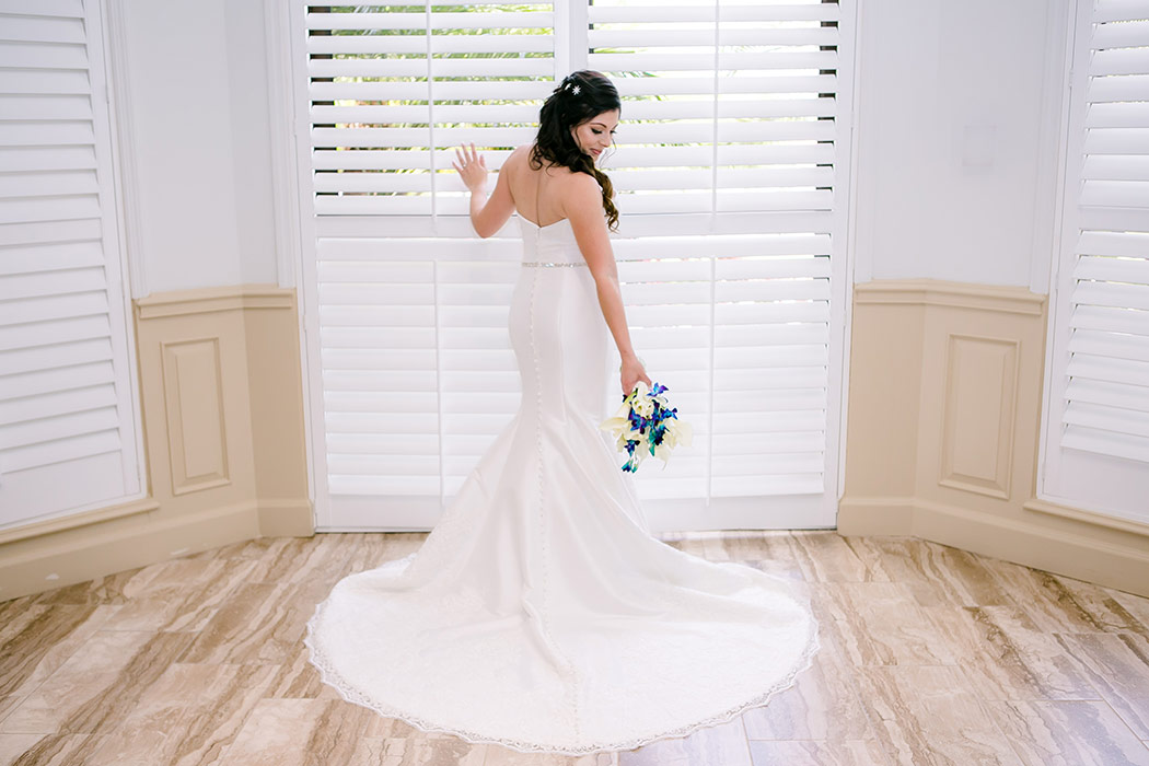 stunning image of bride at window in wedding dress at breakers west country club | photograph of bride in wedding dress at window