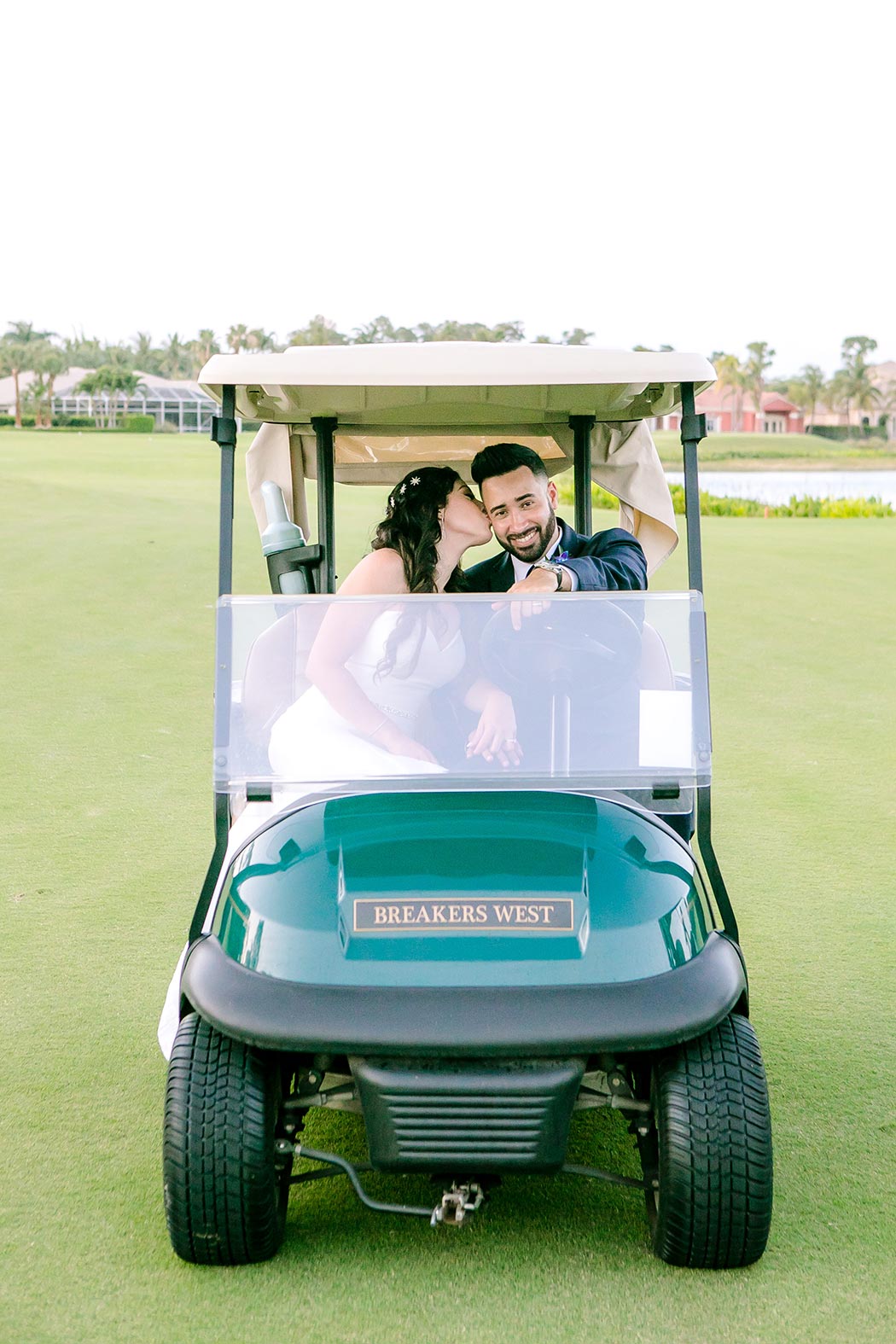 bride and groom fun picture in golf cart