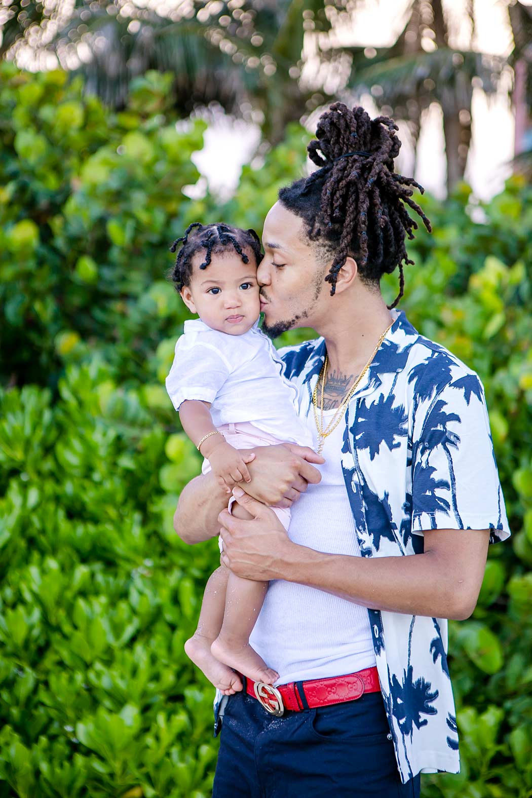 family hugging on the beach during a photography session | fort lauderale family photography | black family pose for family photos | black family beach photoshoot