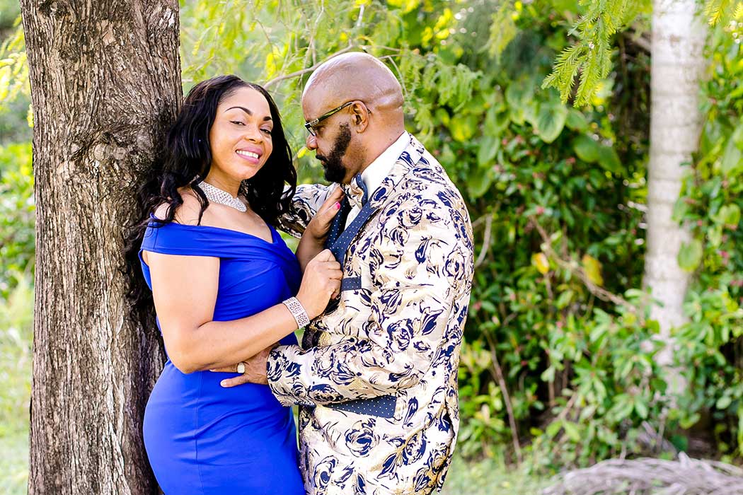unique fun picture of engagement session in park with large tree | engagement photographer fort lauderdale | black couple engagement tree tops park photography