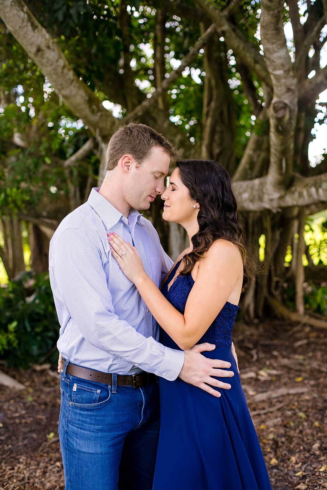 unique fun picture of engagement session in park with large tree | engagement photographer fort lauderdale | south florida engagement photography in robbins preserve davie | elegant engagement session photos fort lauderdaley
