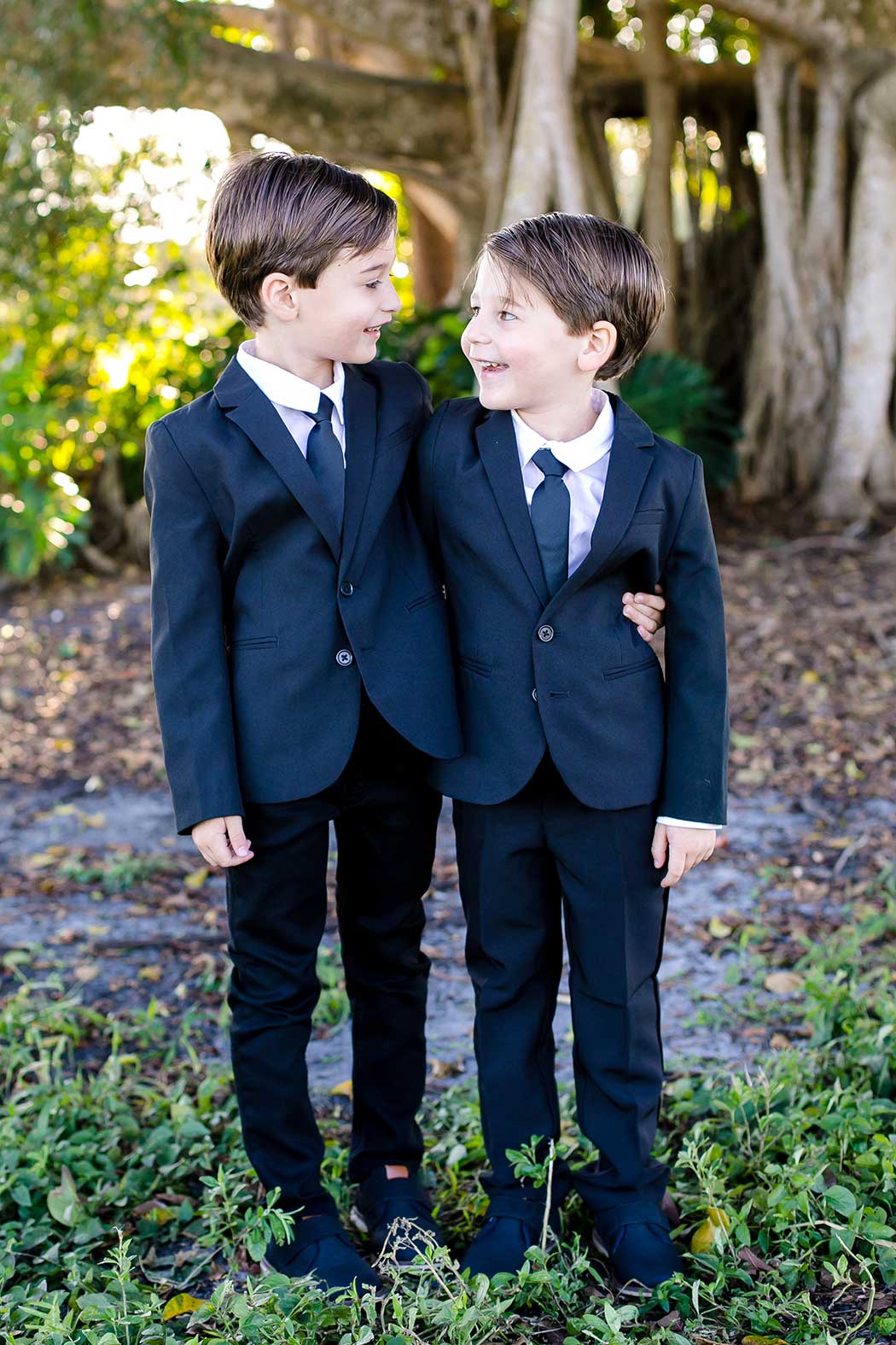 twin boys pose for photo | twin 5-year old boys photographs | family photo session fort lauderdale | family photographer robbins preserve fort lauderdale | elegant family photoshoot