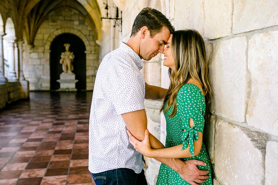 romantic photoshoot at ancient spanish monastery | couple pose for engagement photos | girl in green summer dress in miami | engagement photographer fort lauderdale | andrea harborne photography
