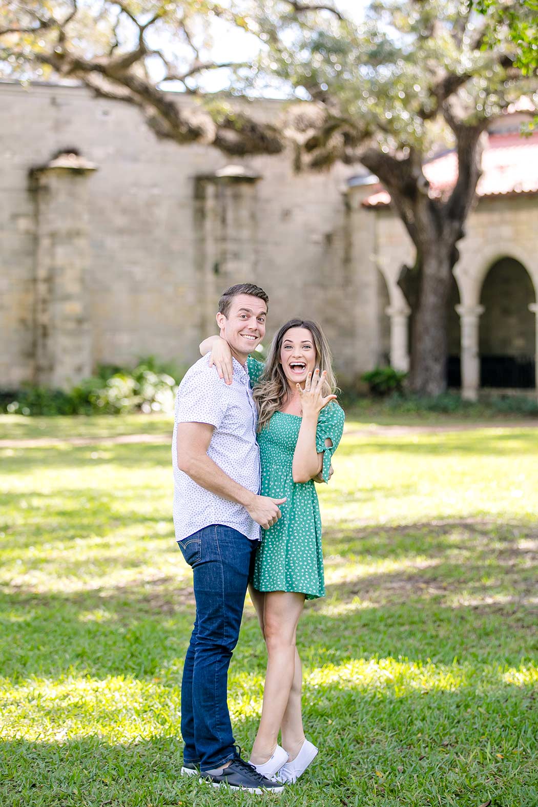 couple celebrate after surprise proposal | ancient spanish monastery proposal | engagement photos ancient spanish monastery | proposal photographer fort lauderdale