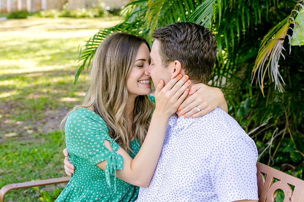 couple posing on bench in garden of ancient spanish monastery | engagement photography pictures | recently engaged couple