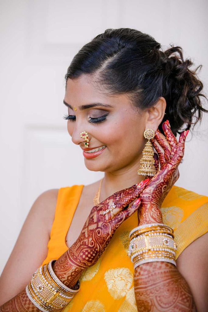 indian bridal pose wearing gold sari