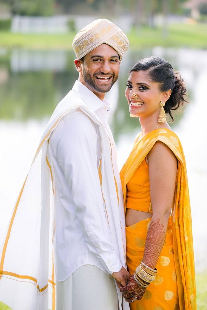indian bride and groom in gold sari