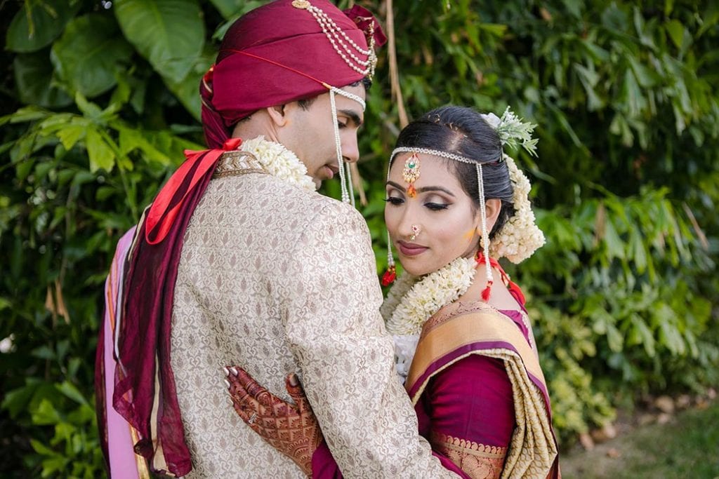 indian bride and groom pose for wedding photograph