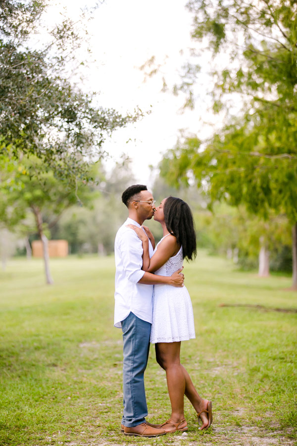 black couple kissing during romantic engagement photoshoot | tree tops park photographer